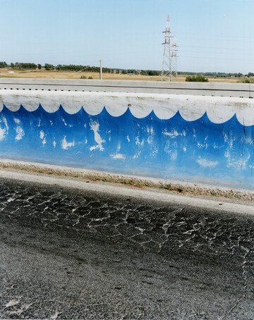 A photo essay exploring cognitive dissonance and leisure, published in the *Miracle issue* of *Noon magazine*. It was shot over several weeks on the Tuscan beach of Rossignano Solvay in Italy. Located adjacent to a Solvay soda ash factory, which releases limestone into the water, the ocean takes on its peculiar colour. As the main employer in the region, the plant is nicknamed by locals "La Mamma". Locals and factory workers come here for its paradisal, exotic qualities, and because it is highly photogenic, but also due to the fact that the extra white.sand enables you to tan faster. *{Special thanks to Sara Giuliattini}* - © Maciek Pożoga