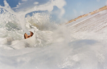 Summer swim in the shorebreak with Arthur, back when our main occupation was mostly doing things like this and going to Uni. - © Maciek Pożoga