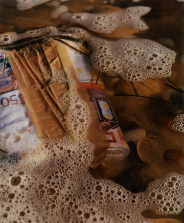 An image from an unfinished series shot on the Atlantic coast in the south-west of France, inspired by the persistent stories among the surf community about finding bundles of cash and pure cocaine on the beach, thrown out by traffickers from their boats when busted. *{Photo assistant : William Fleming}* - © Maciek Pożoga
